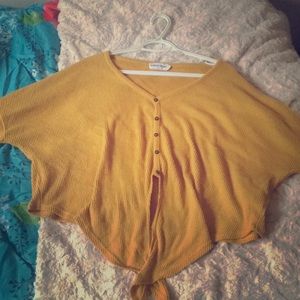 A crop top yellow knitted material sweater